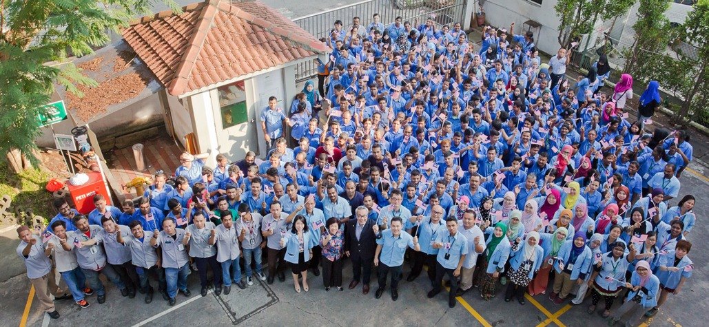 Aerial photo of the MYM Technology team waving Malaysian flags